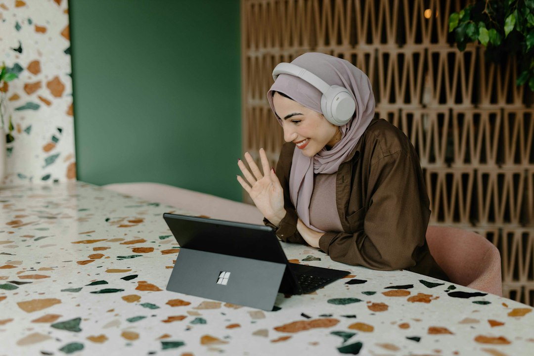 Muslim woman using laptop for customer support